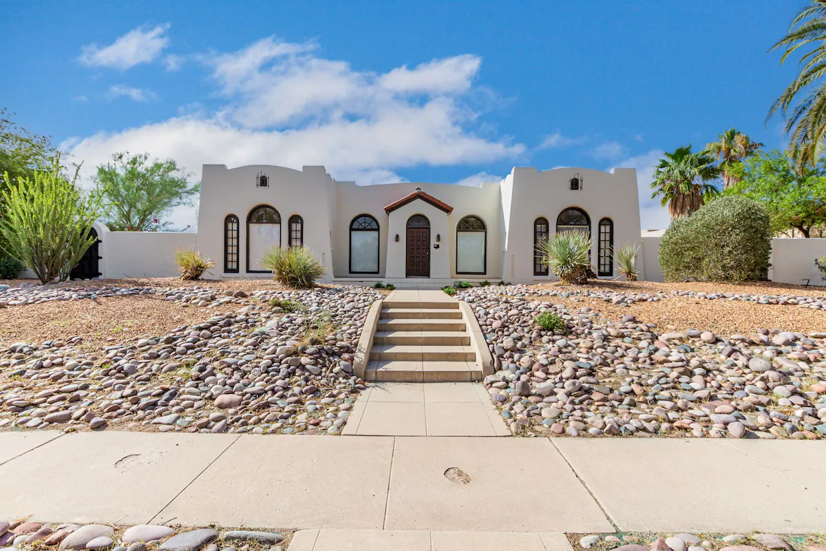 Tucson retreat home, front of large house, sand colored with stone steps