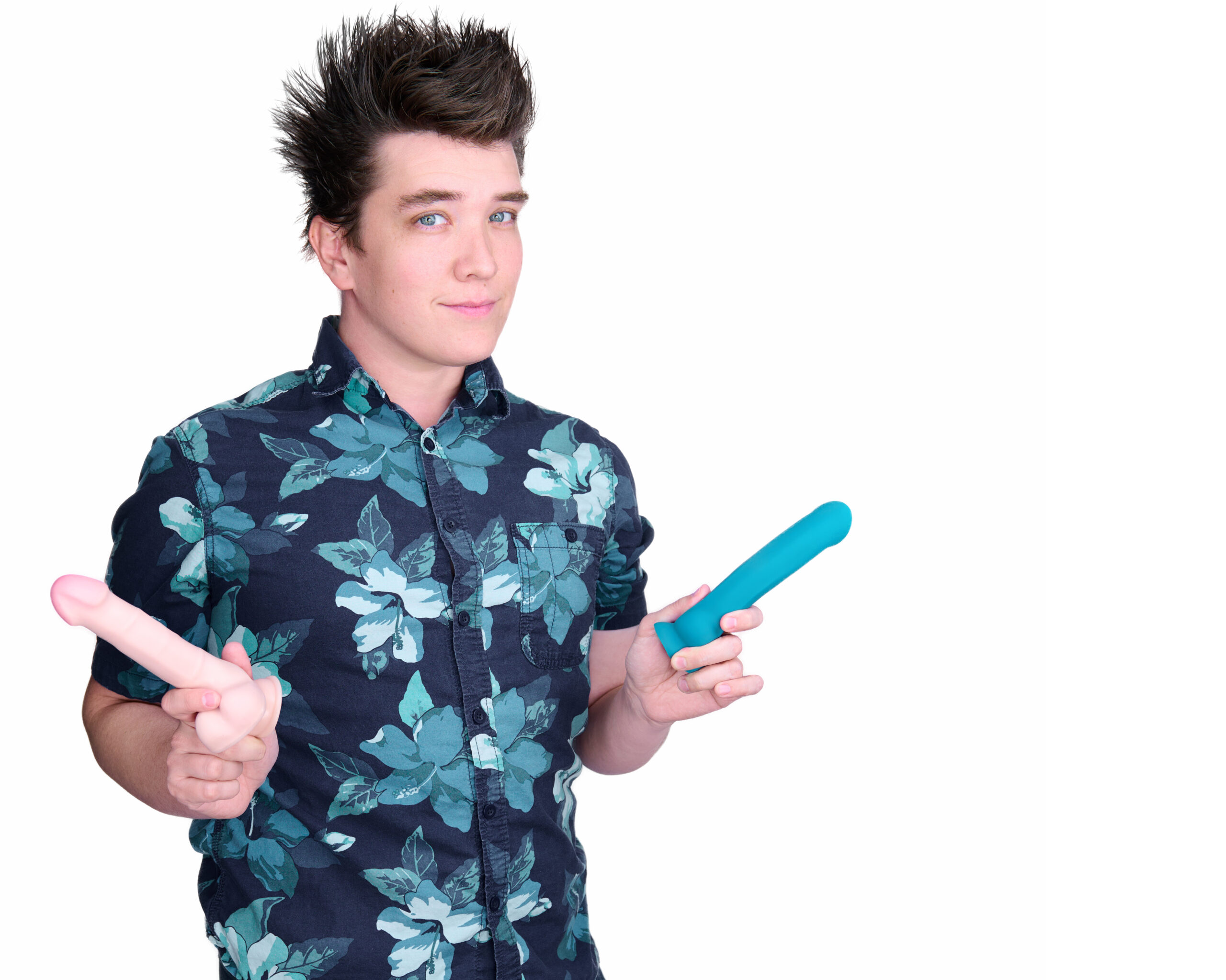 Matt Sosa has short brown spiky hair and brown eyes. He is wearing a blue flowered Hawaiian shirt and holding two vibrators.